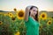 Teenage girl standing in a field of sunflowers