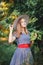 Teenage girl standing near an apple-tree