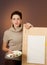 Teenage girl stands behind easel with empty sheet