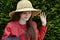 Teenage girl with straw hat says goodbye