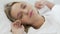 Teenage girl stretching in bed after healthy sleep on soft bed linen, closeup