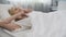 Teenage girl stretching herself, waking up after sleep on orthopedic mattress