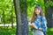 Teenage girl student writing in notebook in park. Preparation for exams at college or university