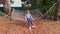 A teenage girl swings on a hammock on a children`s Playground in the Park.