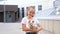 Teenage girl in t-shirt holds small puppy in arms smiling