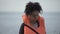 Teenage girl taking life jacket of parent lost in hurricane, disaster victim