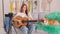 A Teenage Girl is Talking, Filming Her Video Blog, Conducting Distance Learning to Play the Guitar. An Attractive Video