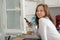 Teenage girl talking with a smartphone near the window