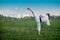 Teenage girl training karate kata outdoors, performs the uro mawashi geri hook kick