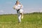 Teenage girl training karate kata outdoors, prepares to yoko geri kick