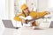 Teenage girl tunning an acoustic guitar in front of a laptop computer