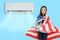 teenage girl with the USA flag under the air conditioner