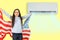 teenage girl with the USA flag under the air conditioner