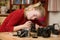 Teenage girl using a small screwdriver to repair an antique film camera