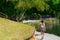 Teenage girl walking away along a path around lake