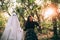 Teenage girl walking by the hand with ghost in forest