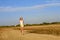 Teenage girl walking on the sandy road