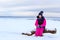 Teenage girl walking on sea shore Narva Estonia