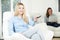 Teenage Girl Watches TV Whilst Mother Works On Laptop