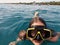 A teenage girl wearing a swim mask to dive