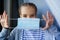 A teenage girl wears a protective medical disposable mask.