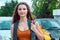 Teenage girl woman in jeans cars dealership on background