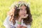 teenage girl with wreath from field Camomile on her head