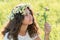 teenage girl with wreath from field Camomile on her head