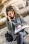 Teenage girl / young student looking at her notebook and smiling - dynamic shot