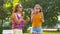 Teenage girls blowing bubbles in summer park