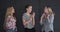 Teenage girls dancing against studio background