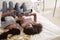 Teenage girls lying on bed using technology, elevated view