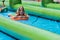 Teenage Girls Slide Down Giant Slip And Slide In Innertubes