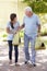 Teenage Granddaughter Helping Grandfather With Shopping