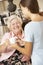 Teenage Granddaughter Making Grandmother Hot Drink At Home