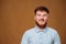 A teenage guy with fiery red hair strikes a pose in the photo studio,