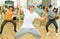 Teenage krump dancer dancing with teenagers in choreographic studio