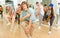 Teenage krump dancer dancing with teenagers in choreographic studio