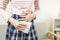 Teenage lady girl holding a sanitary napkin in hand,painful menstruation or abdominal cramps,asian student clutches stomach with