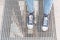 Teenage legs wearing denim sneakers of flowers, standing on a street grid. Street hipster style.