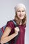 Teenage Medical Ideas. Portrait Of Caucasian Teenager Girl Wearing Teeth Brackets. Posing with Backpack Indoors