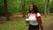 Teenage mixed race African American girl young woman hiking in forest woodland