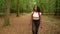 Teenage mixed race African American girl young woman hiking in forest woodland