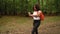 Teenage mixed race African American girl young woman hiking with orange backpack, smart watch and takeaway coffee cup