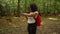 Teenage mixed race African American girl young woman hiking and wearing a smart watch in forest woodland