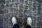 Teenage person in sneakers standing on paving stones