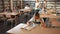 Teenage pupils sitting at table and studying, teacher in classroom