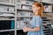 Teenage redhead girl is carrying plastic box with little dry paint jars