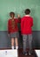 Teenage Schoolchildren Writing On Board