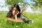 Teenage schoolgirl reading book in grass